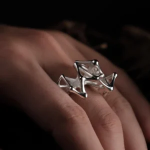 Leaping Orbit Handcrafted 999 Fine Silver Statement Ring with angular geometric design, worn on hand; a sculptural Silver Statement Ring featuring polished interconnected shapes, styled with natural skin contrast.