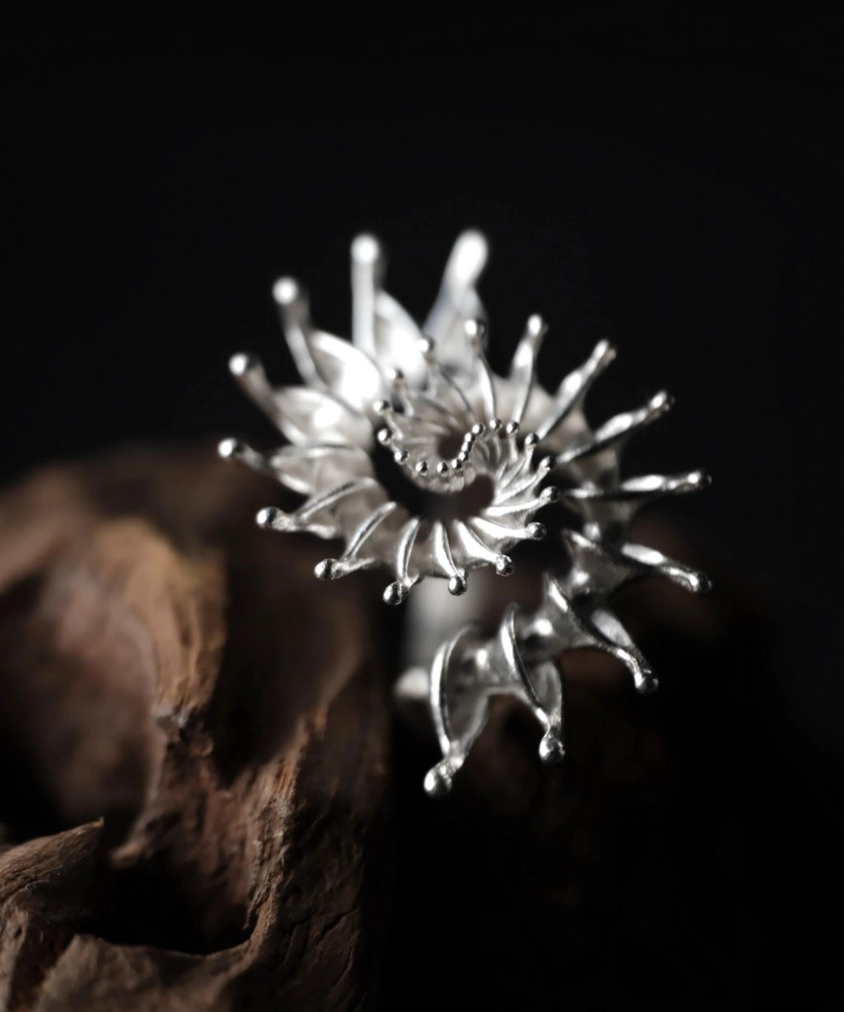 S925 Sterling Silver Spiral Ring Jewelry-Handmade Artistic Statement Ring 01 S925 Sterling Silver Spiral Ring Jewelry with symmetrical petal-like extensions and rounded tips, placed on textured wood against a dark background; bold Statement Ring showcasing sculptural elegance and intricate Silver Ring craftsmanship.