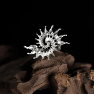 S925 Sterling Silver Spiral Ring Jewelry with radiating petal-like extensions in a fractal-inspired sunburst design, placed on driftwood against a black background; bold Statement Ring showcasing sculptural elegance and intricate Silver Ring craftsmanship.