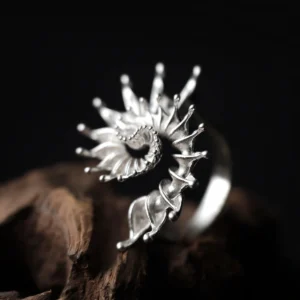 Side view of handmade S925 sterling silver spiral ring jewelry with flowing, organic curves. Sculptural silver ring inspired by natural spirals, artistic statement ring design with textured silver finish.