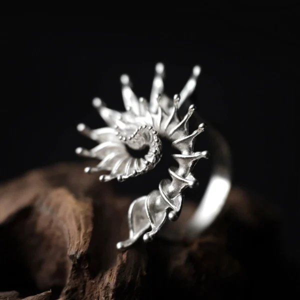 Side view of handmade S925 sterling silver spiral ring jewelry with flowing, organic curves. Sculptural silver ring inspired by natural spirals, artistic statement ring design with textured silver finish.