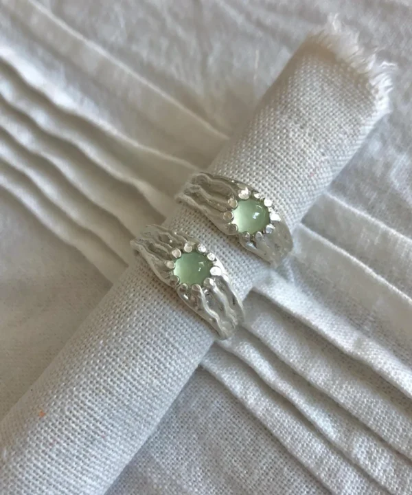 New In 33 Silver Gemstone Rings with pale green prehnite set in textured 999 silver bands, placed on white fabric.