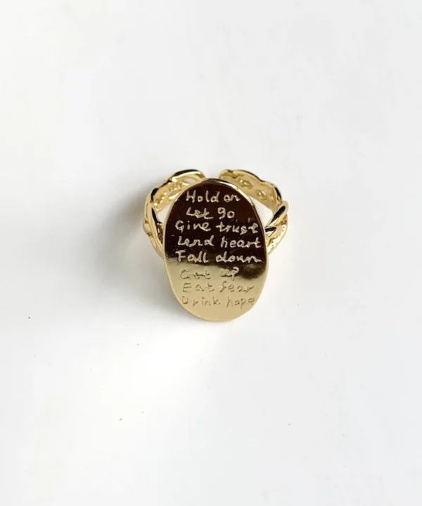 Engraved poetry ring in 14K gold-plated sterling silver with oval face and open intertwined band