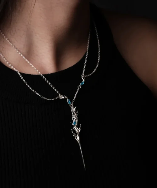 Elven Necklace with silver antler-inspired pendant and blue gemstones; worn over black ribbed top, featuring fantasy elegance and handcrafted S925 sterling silver artistry.