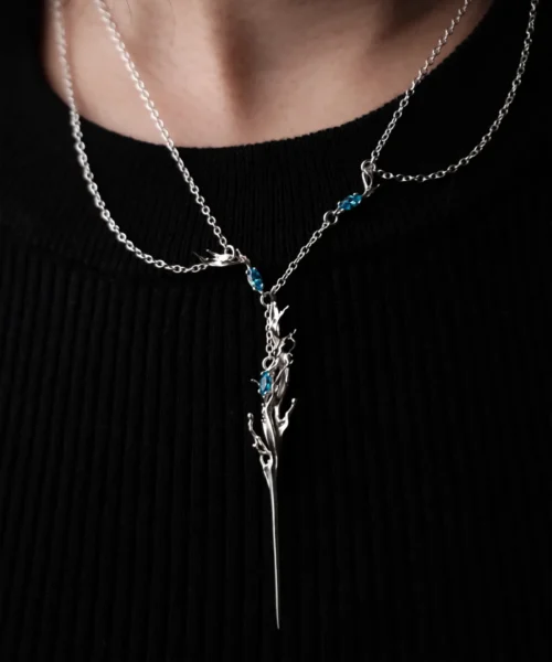 Elven Necklace with silver branch-like pendant and blue gemstones; worn over black ribbed top, featuring fantasy-inspired design and elegant craftsmanship in S925 sterling silver.