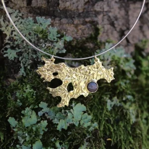 Tree Lichen Pendant on a silver choker necklace with natural agate; gold-toned organic pendant with embedded stone, styled against moss and bark to highlight forest-inspired craftsmanship and poetic botanical elegance.