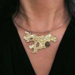 Tree Lichen Pendant on a silver choker necklace with natural agate; worn over black fabric to highlight the gold-toned organic pendant with embedded stone, showcasing forest-inspired elegance and handcrafted detail.