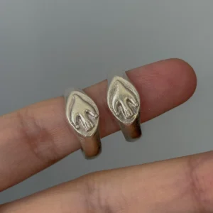 Flying Bird Ring-Handmade 999 Silver Signet Pinky Ring 15 Hand wearing two silver Signet Pinky Rings with identical raised sculptural motifs, shown against a neutral background that highlights the rings’ polished texture.