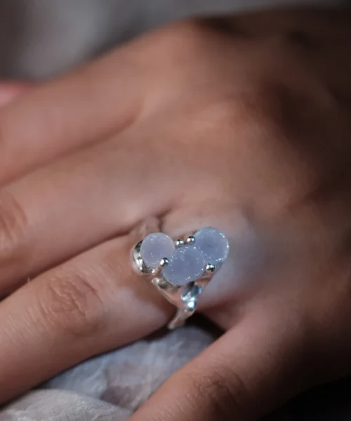 A delicate Custom Gemstone Ring in polished sterling silver, featuring three soft lavender gemstones in an organic setting.