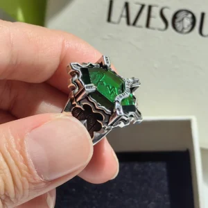 Close-up of the handmade Vongola Lightning Ring from Katekyo Hitman Reborn! with green gemstone, held by hand.