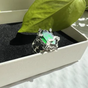The handmade Vongola Lightning Ring from Katekyo Hitman Reborn! with a faceted green gemstone is displayed in a gift box.