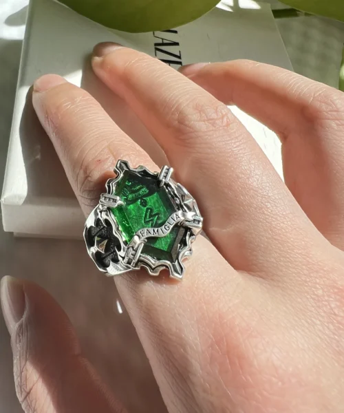 Close-up of a hand wearing the handmade Vongola Lightning Ring from Katekyo Hitman Reborn! with a green lightning symbol gemstone.