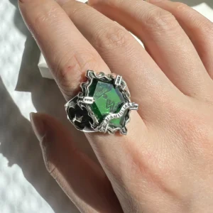 A close-up of a hand wearing the handmade Vongola Lightning Ring from Katekyo Hitman Reborn! with a central green gemstone.