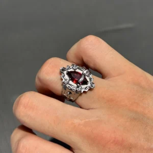Close-up of a hand wearing the handmade Vongola Ring from Katekyo Hitman Reborn! with a faceted red gemstone.