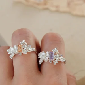 Two Unique Gemstone Ring on fingers, orchid-inspired S925 silver rings with central orange and purple rectangular gemstones.