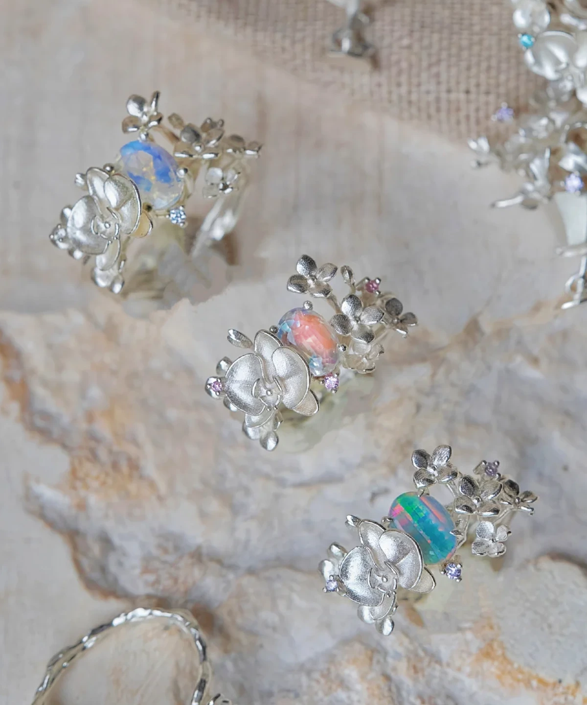 Three Unique Gemstone Ring in S925 silver, orchid-inspired design with iridescent opal-like cabochon gemstones.