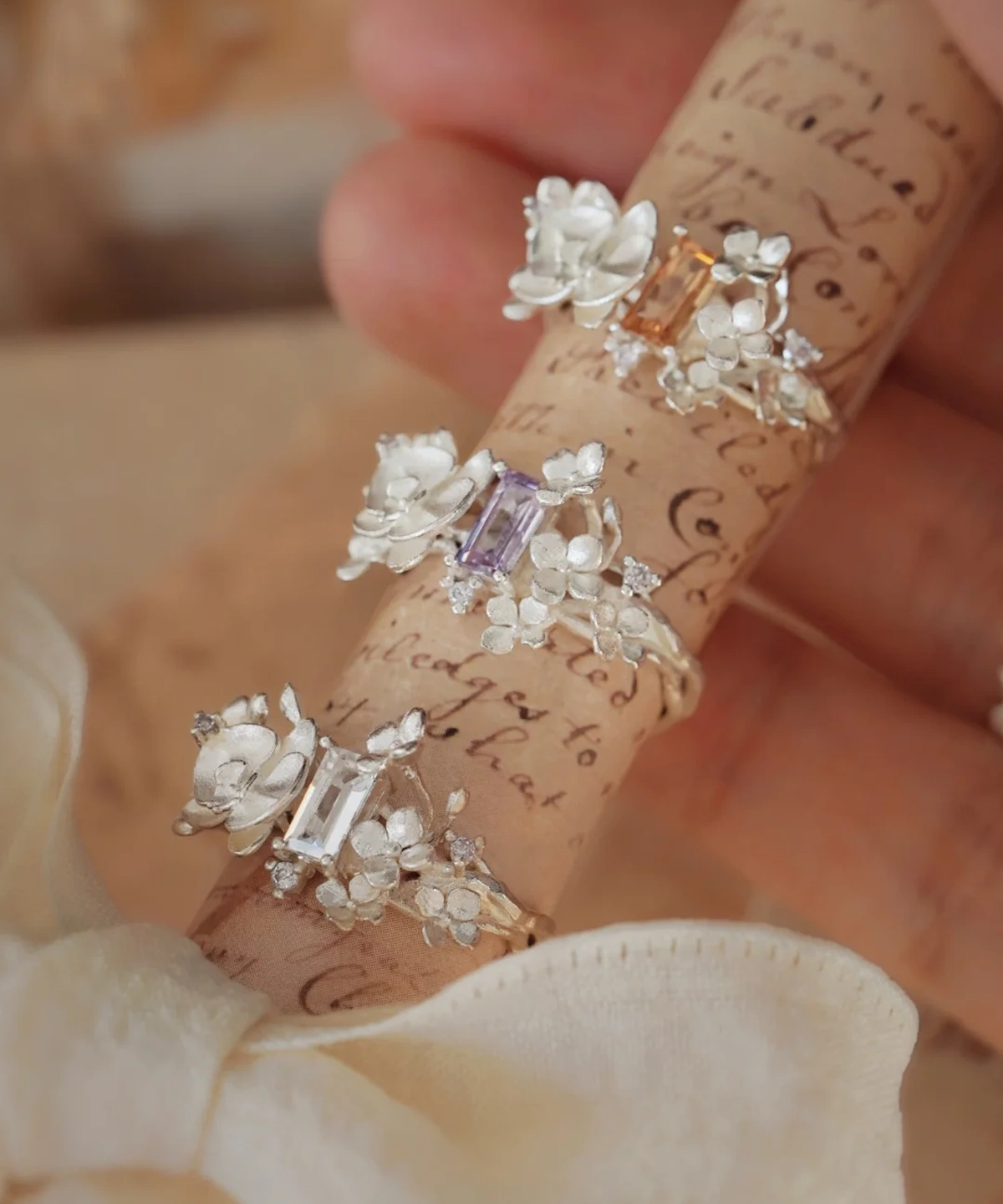 Three Unique Gemstone Ring in S925 silver, orchid-inspired design with clear, purple and yellow rectangular-cut gemstones.