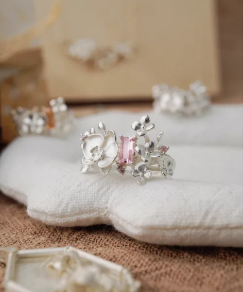 Close-up of the Unique Gemstone Ring, an orchid-inspired S925 silver ring with a central pink rectangular-cut gemstone.