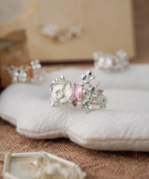 Close-up of the Unique Gemstone Ring, an orchid-inspired S925 silver ring with a central pink rectangular-cut gemstone.