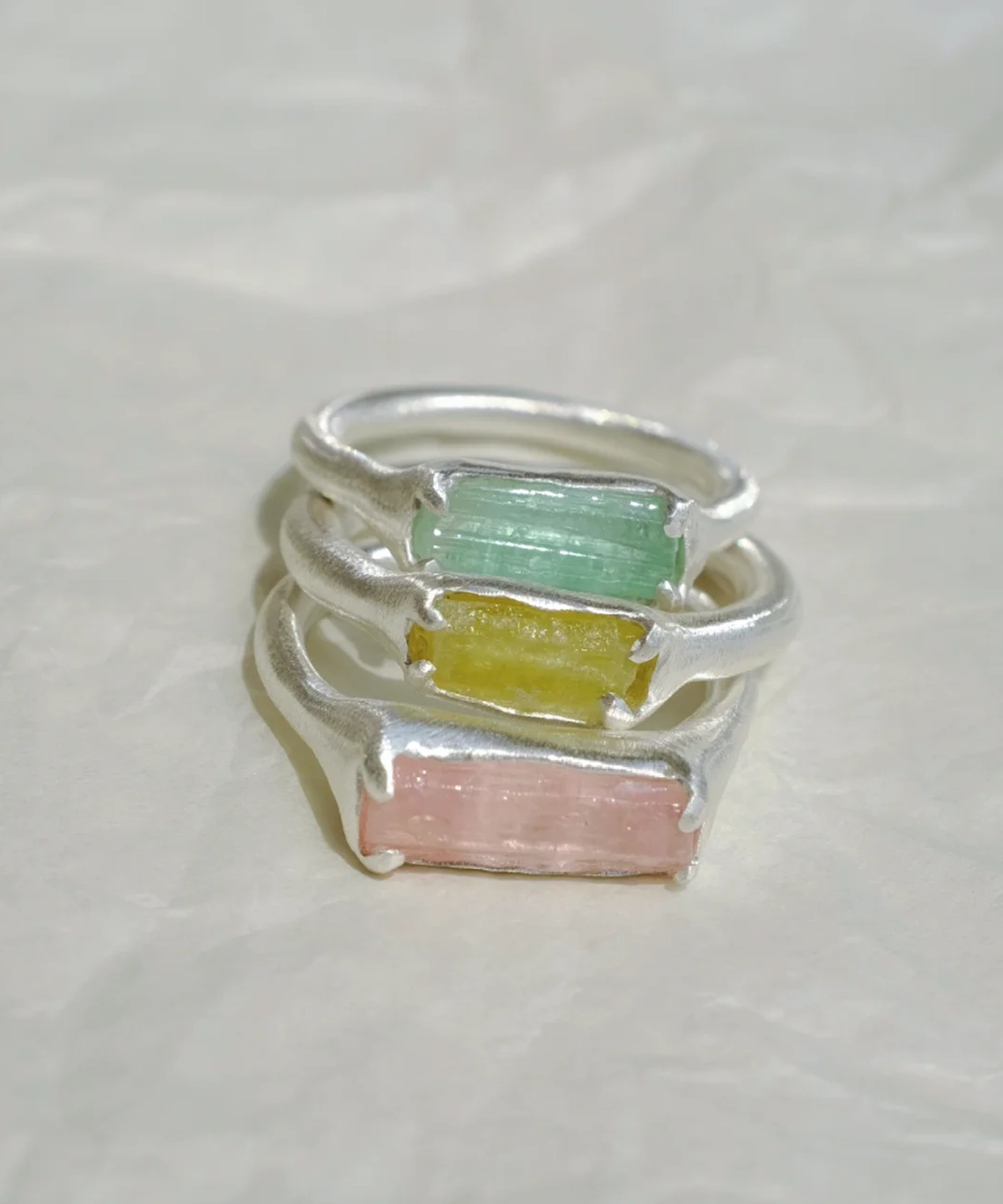 Three stacked Custom Couple Rings in S925 silver, featuring natural green, yellow, and pink tourmaline gemstones.