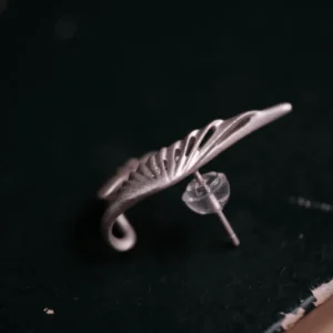 Close-up of a Dual Wing Earring in S925 sterling silver, showing the detailed wing design and post with earring back.