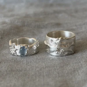 Two Lazesoul 999 silver rings on linen, aquamarine gemstone ring and cowboy horse wide band