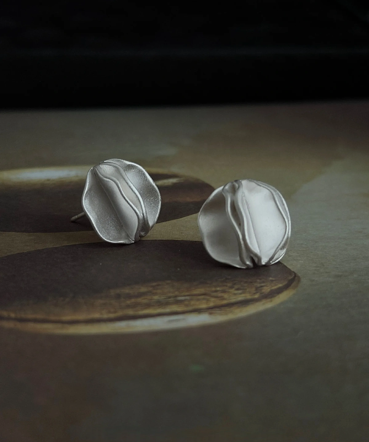 Sculptural Silver Stud Earrings – Vintage Tray Lifestyle sculptural silver stud earrings on vintage metal tray, handmade jewelry lifestyle