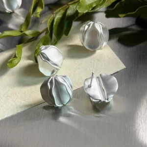 Sterling Silver Stud Earrings – Natural Light with Botanicals sterling silver stud earrings displayed with green plants, natural light