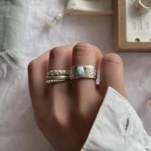 handmade larimar ring styled with stacking rings white background lifestyle