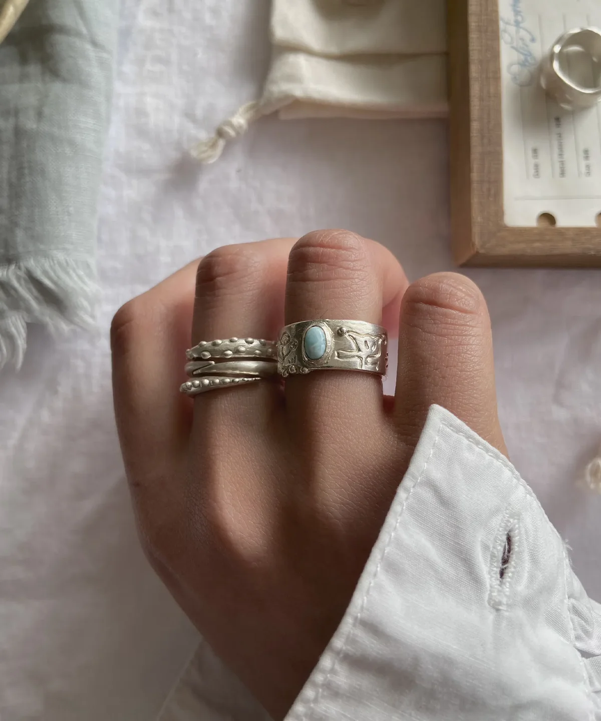 Larimar Ring Stacked – Lifestyle Styling with Silver Rings handmade larimar ring styled with stacking rings white background lifestyle