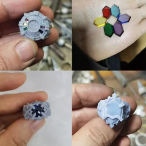 Wax carving process for handmade anime rings — wax model with gemstones in place, natural guardian element stones in hand, and two wax ring prototypes showing crest and shield details before sterling silver casting
