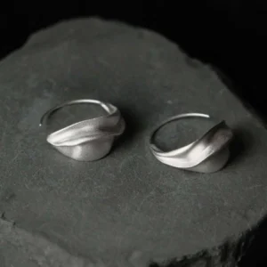 crescent moon hoop earrings in silver, pair on dark stone showing compact threader shape