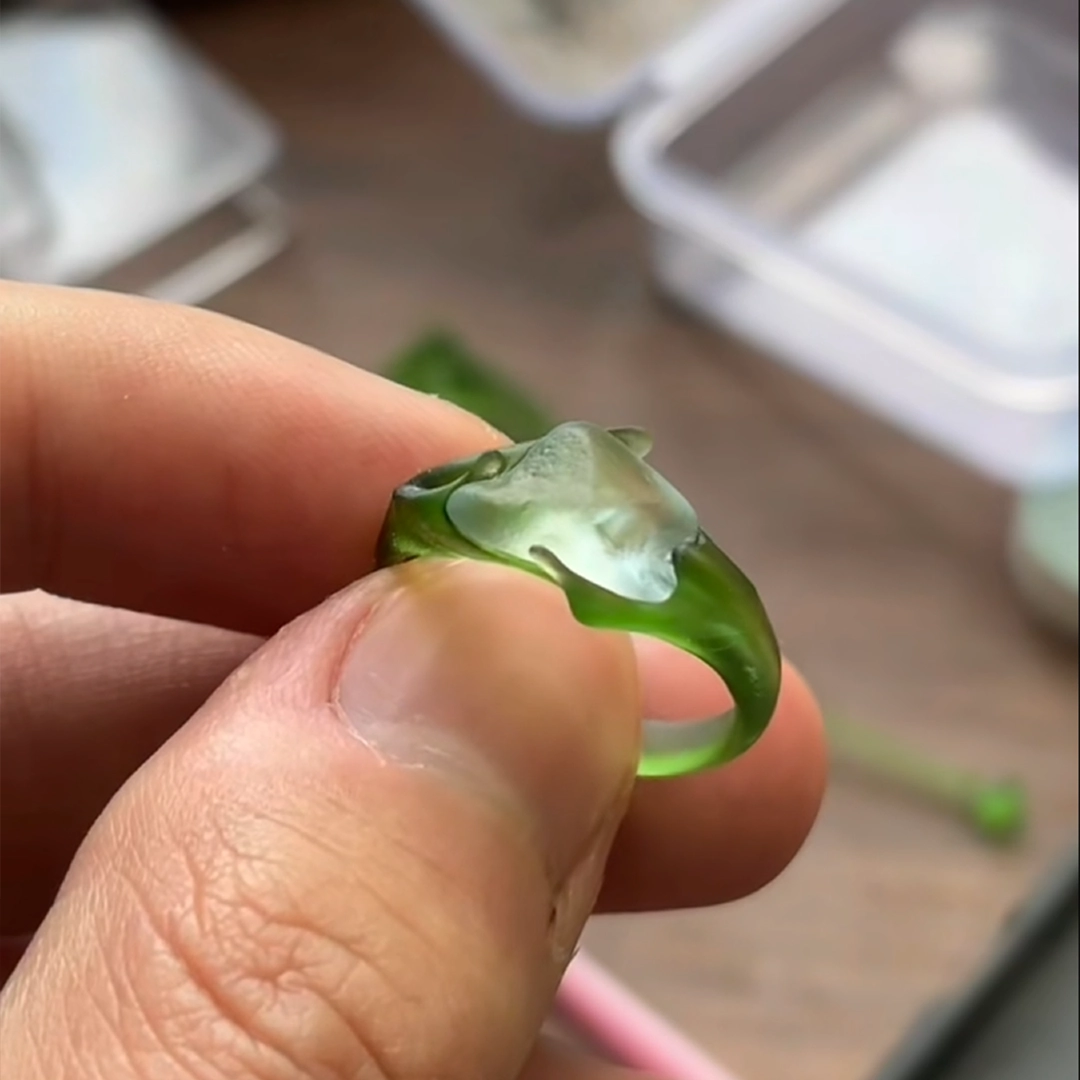 Green wax model for a freeform aquamarine custom ring, shaped by hand before silver casting.