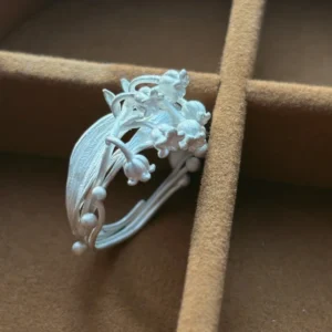 silver lily of the valley ring top view in jewelry box, handmade floral detail