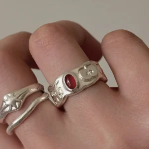 Handcrafted 999 silver apple ring with red carnelian cabochon worn on finger