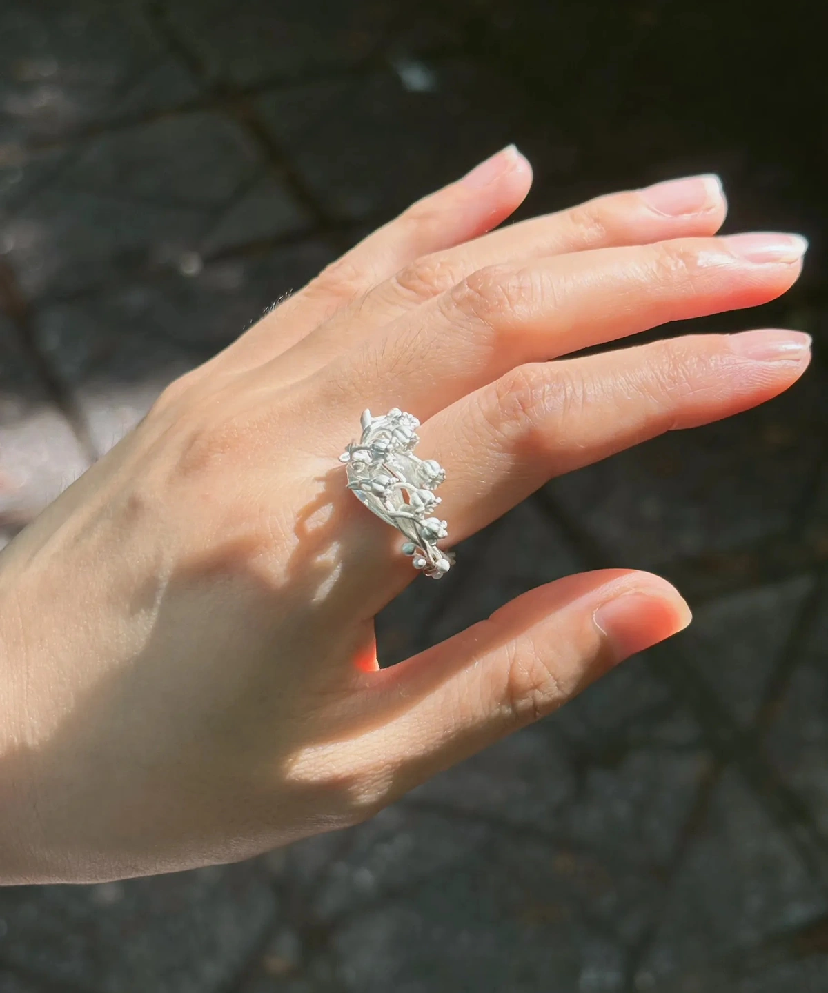 handmade sterling silver lily of the valley ring worn in sunlight, May birth flower ring