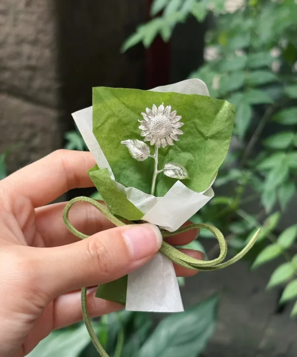 silver sunflower gift single stem wrapped in green paper with suede tie, handmade sterling silver