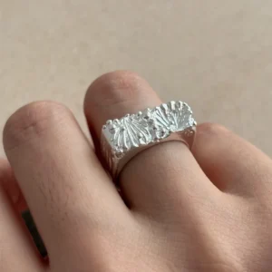 wide silver band ring worn on finger showing shell texture face, 999 fine silver Tidemark ring