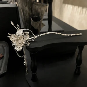 950 silver iris flower hair stick with a long textured stem and hanging chains displayed on black