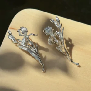 Bud and leaf silver iris earrings in S925 displayed as a pair with blooms, unopened buds, and layered leaves