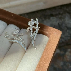 S925 iris earrings with buds and long leaves viewed from above in a jewelry box