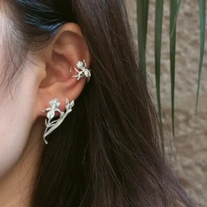 Bud and leaf silver iris earring worn along the lobe with a branching botanical silhouette