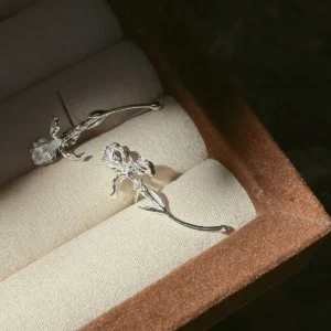 Curved stem silver iris earrings in S925 displayed as a pair with single blooms and long fluid lines
