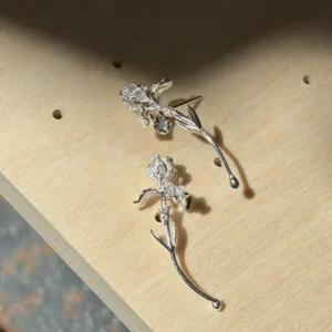 Curved stem silver iris earrings viewed from the reverse with fixed posts visible