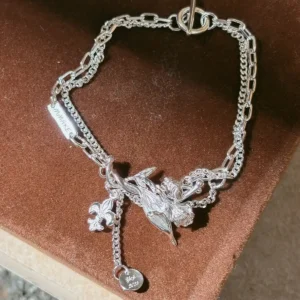 Personalized silver iris bracelet with layered chains, sculpted flower and engravable charms