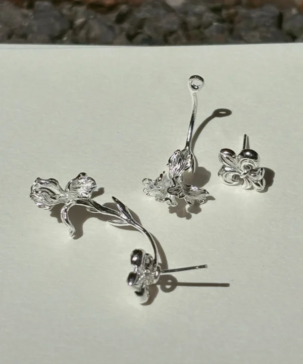 Silver iris ear jacket earrings in S925 shown as separate fleur-de-lis studs and long-stem iris jackets