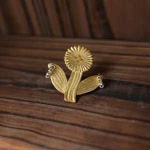 Round fringe-petal gold flower stud earring on warm wood (Style 1)