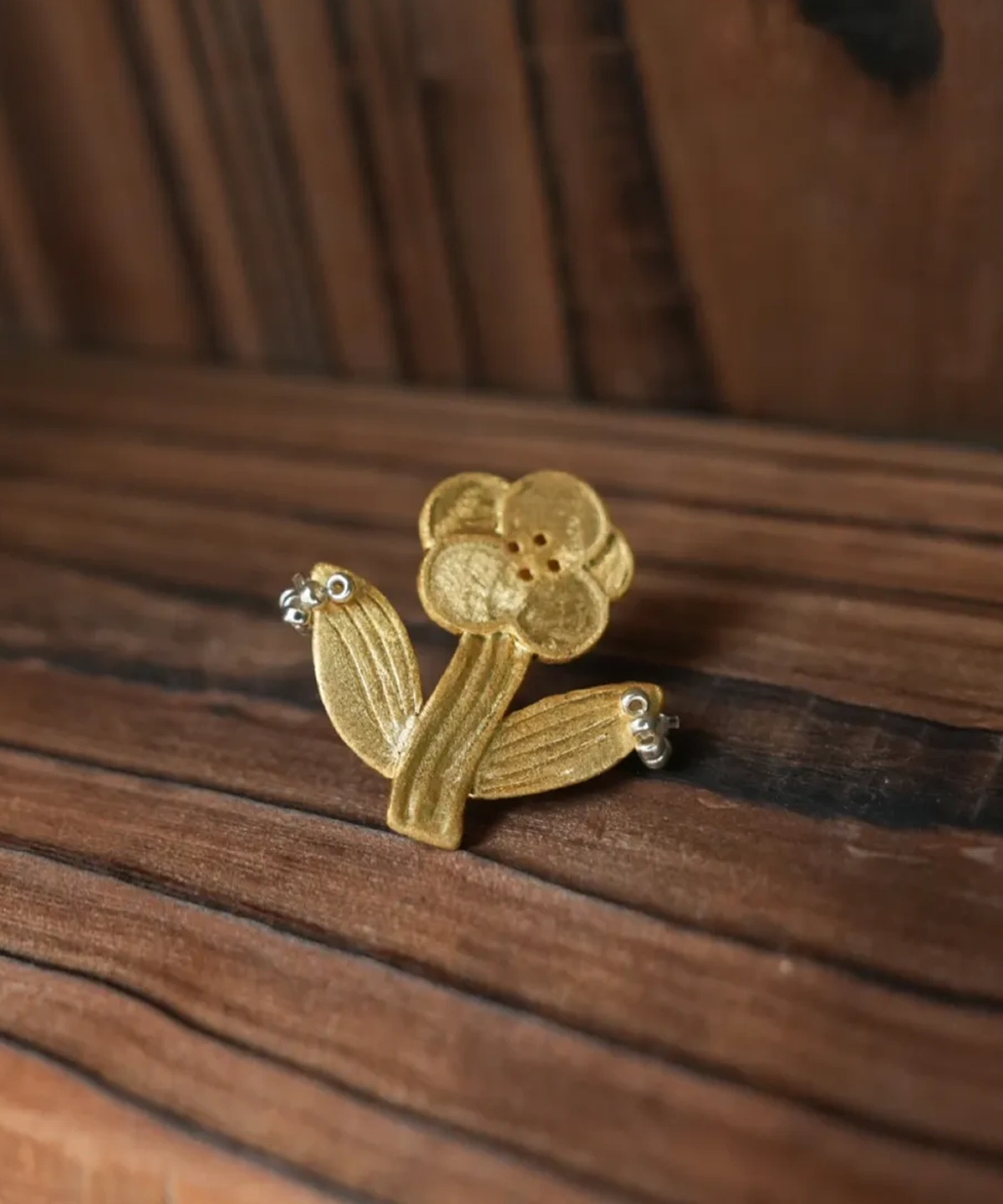 Gold flower stud earring with rounded overlapping petals and small beads at the leaf tips (Style 3)