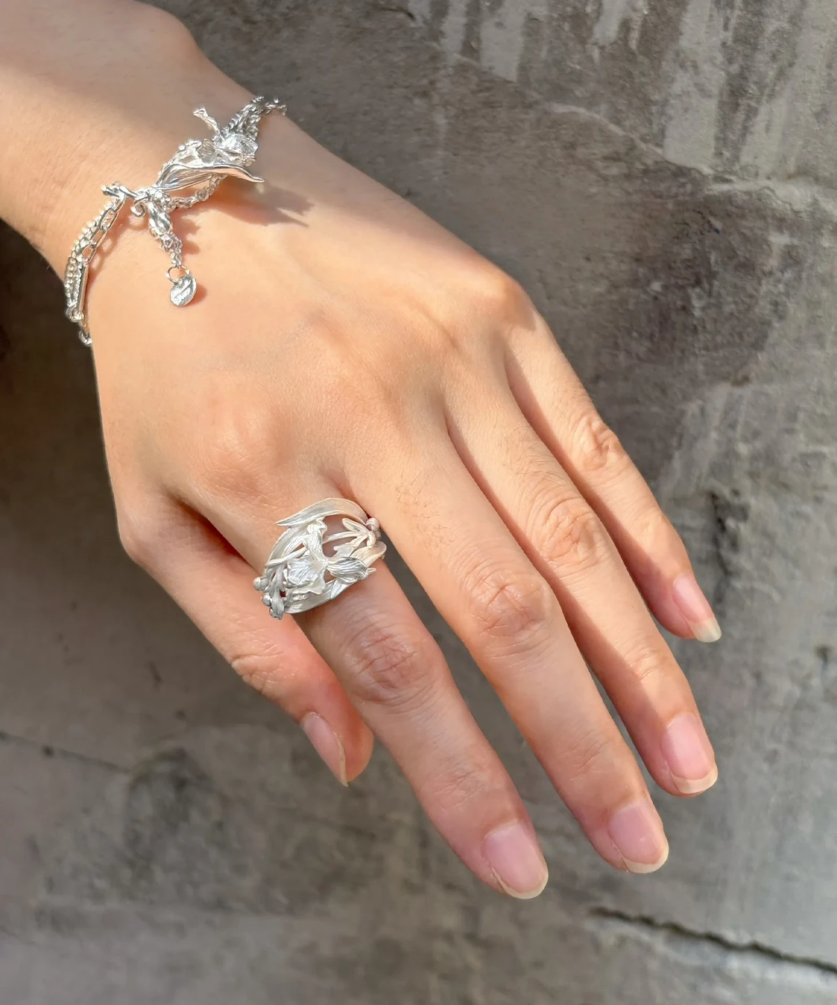 Silver iris ring worn with a matching iris bracelet in S925 sterling silver