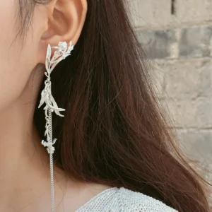 Sterling silver shoulder duster earring with iris flowers, articulated leaves, and a long moving chain